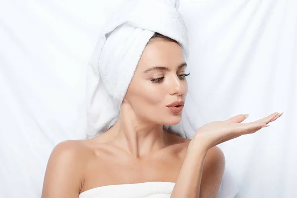 beautiful and natural young woman with turban towel on head, skin care, hydrated skin, treatment concept