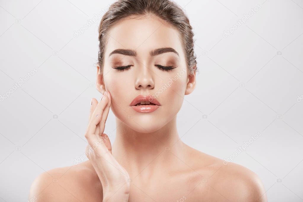 beauty portrait of young woman posing at grey background,  skin care and hydrated skin concept 