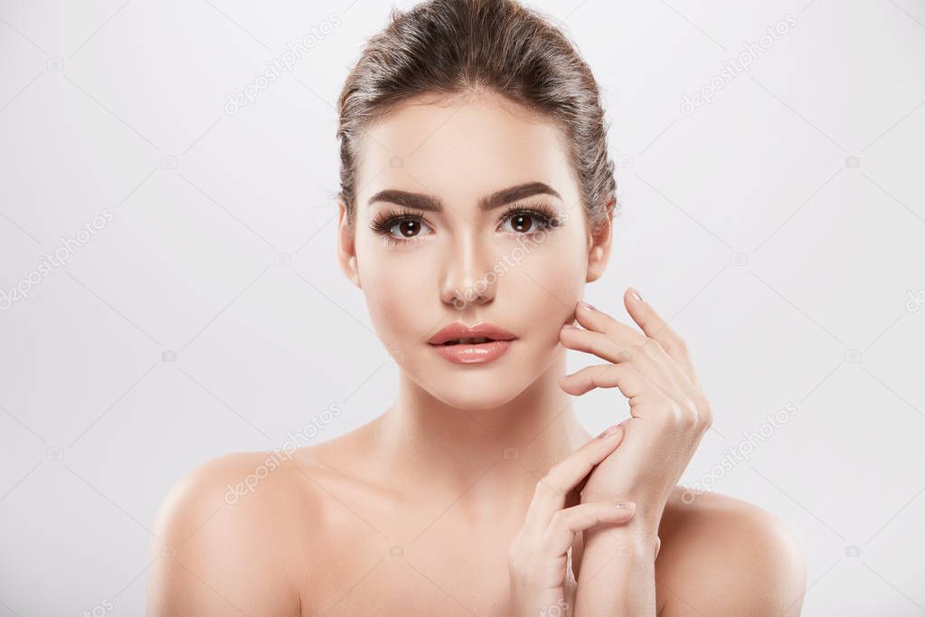 beauty portrait of young woman posing at grey background,  skin care and hydrated skin, concept 