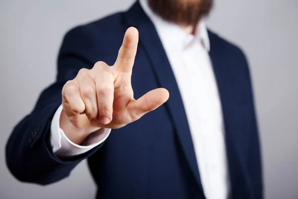 cropped photo of businessman in suit showing attention sign