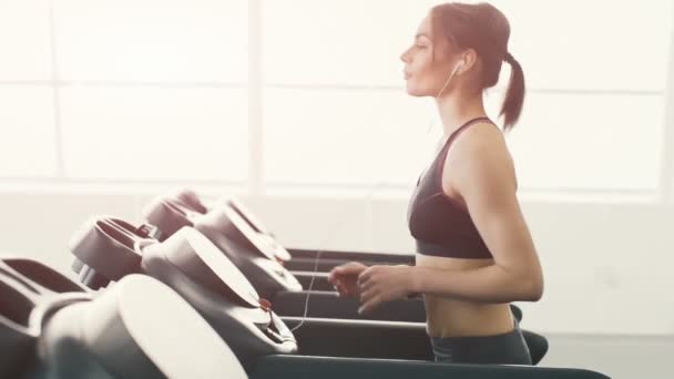 Pretty girl jogging in gym — Stock Video