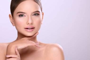 sabit saçlı ve çıplak mor arka plan üzerinde poz makyaj çekici genç kadın portresi