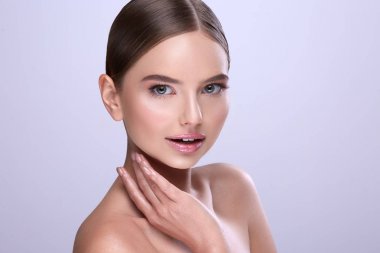 sabit saçlı ve çıplak mor arka plan üzerinde poz makyaj çekici genç kadın portresi