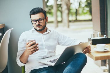 young handsome businessman working alone in cafe