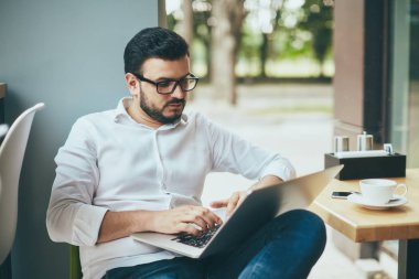 young handsome businessman working alone in cafe