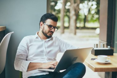 young handsome businessman working alone in cafe