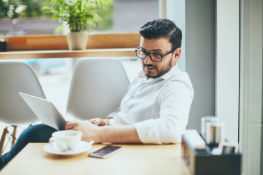young handsome businessman working alone in cafe