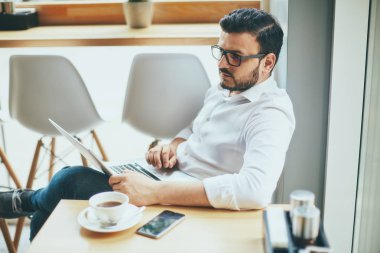 young handsome businessman working alone in cafe