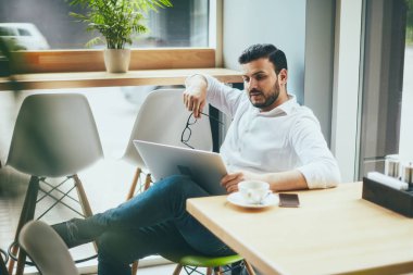 young handsome businessman working alone in cafe