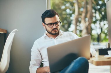 young handsome businessman working alone in cafe