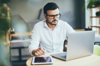 young handsome businessman working alone in cafe