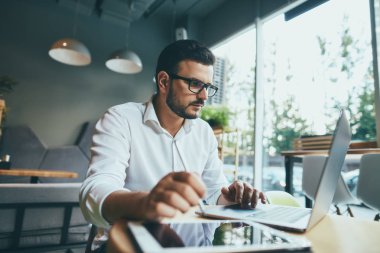 young handsome businessman working alone in cafe
