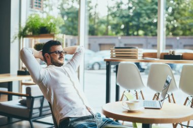 young handsome businessman working alone in cafe