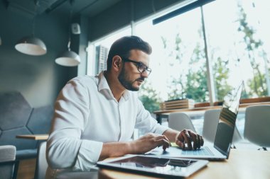 young handsome businessman working alone in cafe