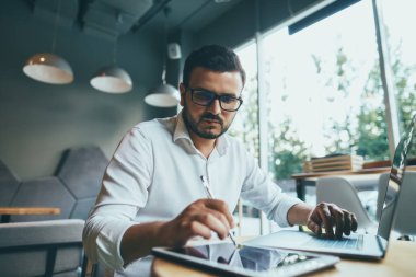 young handsome businessman working alone in cafe