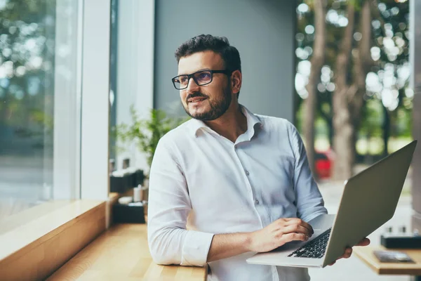 young handsome businessman with eyeglasses working in cafe