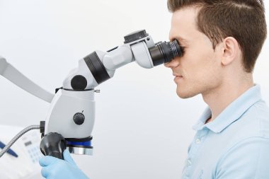 young male dentist in modern dental clinic