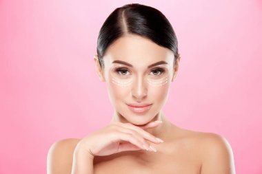 young attractive woman posing on pink backdrop
