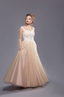 gri zemin üzerinde poz kırmızı ruj ile zarif elbise güzel kadın