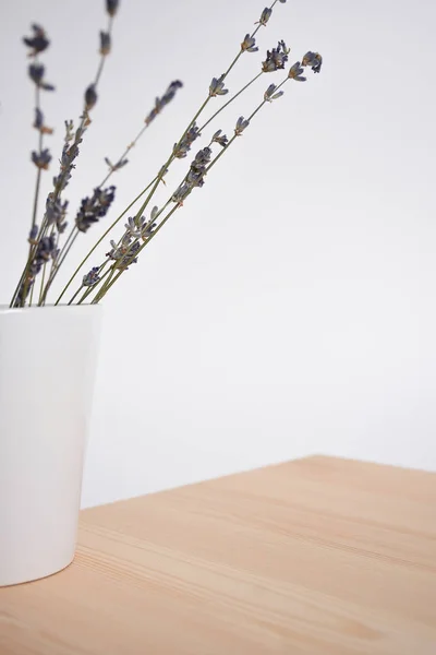 Lavender in a white mug on a table on a light background