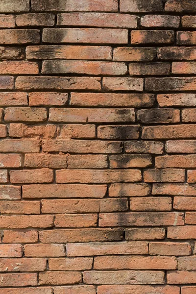 Eine Mauer aus Ziegelsteinen. Grunge Backsteinmauer Hintergrund. Hintergrund von o — Stockfoto