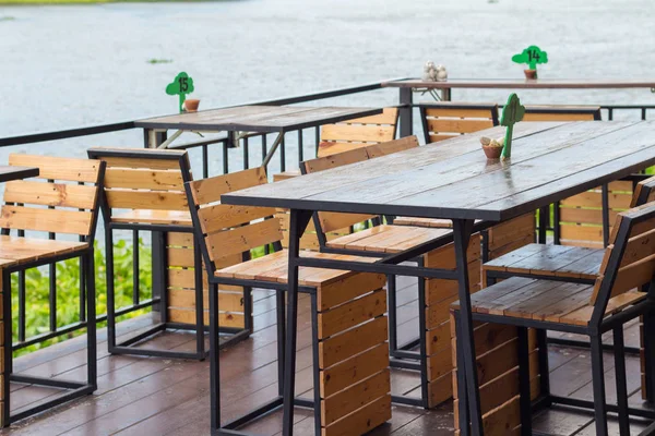 Mesa de comedor en el acogedor café al aire libre. Mesa de comedor junto a la r — Foto de Stock