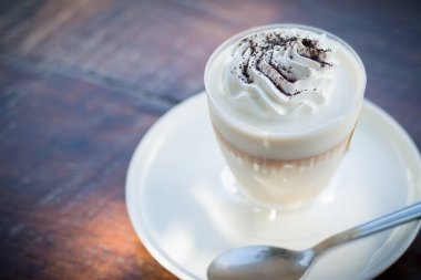 Ahşap masa peçeteye üzerine rendelenmiş çikolata ile lezzetli süt puding