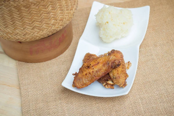 Fried chicken wings and crispy garlic with sticky rice(selective focus)