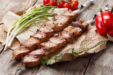 ahşap bir masa üzerinde domuz şiş, seçici odak