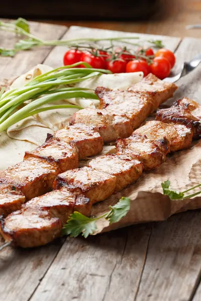 Pork skewers on a wooden table, selective focus — Stock Photo, Image