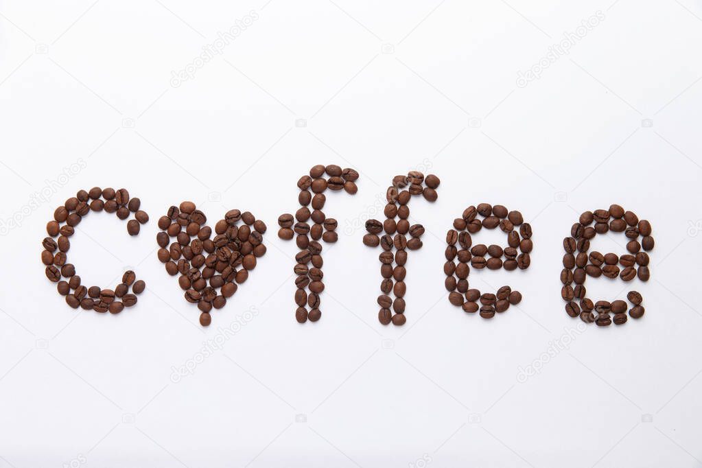 word coffee lined with coffee beans on white background