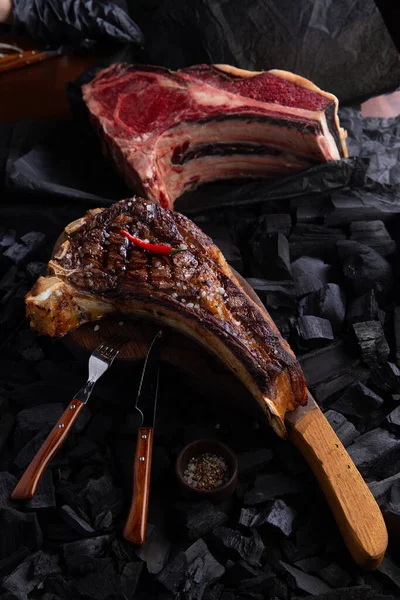 Ready tomahawk steak on a background of coals. Selective focus