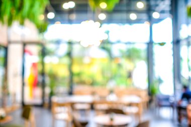 Kafede ya da kafeteryada bulanık, soyut Bokeh ışıklandırması arka planında..