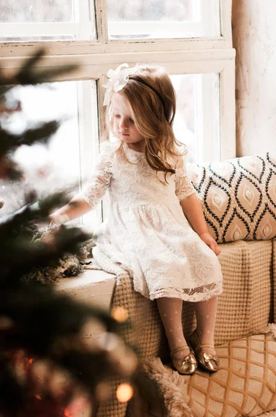Charming Little Girl Lace Dress Sits Windowsill Away Christmas Tree — Stock Photo, Image