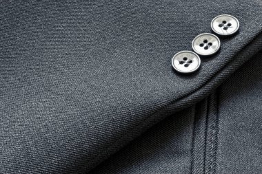 Close up of a few buttons on a business suit coat clipart