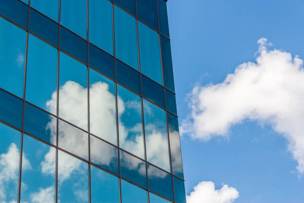 Clouds reflected in windows of a modern office building