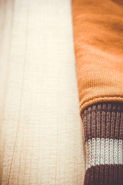 Verticale Close Van Een Oranje Blouse Mouw Houten Ondergrond — Stockfoto