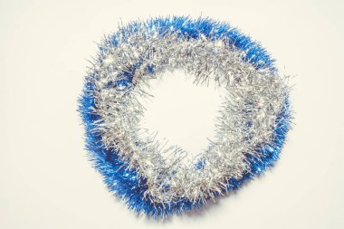 Yeşil çam yaprakları üzerine mavi ve gümüş süslemeli Noel arkaplanı. Metin için yuvarlak kopyalama alanı