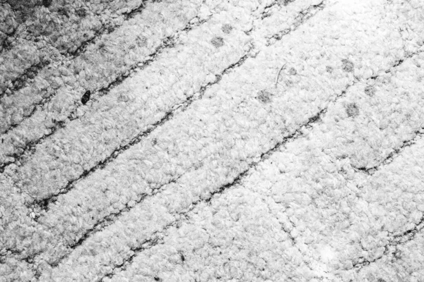 Black and white image of a fluffy carpet made from cotton