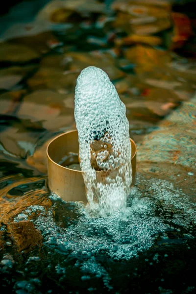 Vertical shot of a water flushing out of a sprinkle