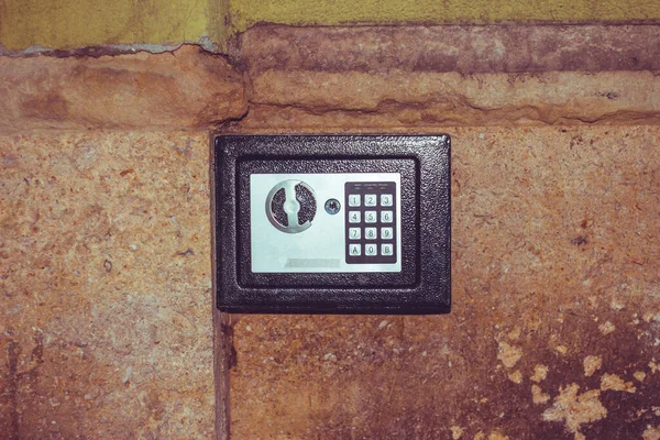 Metallic digit panel of a safe box in a wall Safe container for personal savings and values Concept image for safety and security