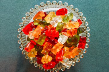 Cam bir patlamaya karıştırılmış renkli ayıcıklar. Meyve aromalı tatlı ve lezzetli ikramlar. Yumuşak desenli şekerleme