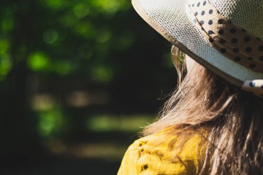 Dışarıda fotokopi çekilen bir yaz gününde şapkalı mutlu genç bir kadın. Neşeli kız güneşin altında oturup rahatlıyor ve kendini iyi hissediyor. İleti kavramı