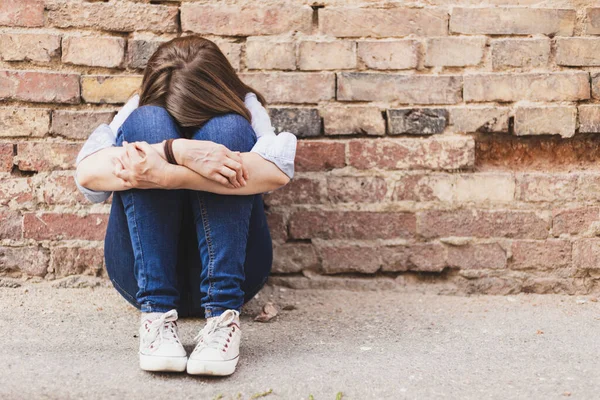 Scared Millennial Girl Sitting Alone City Next Brick Wall Casually — Stock Photo, Image