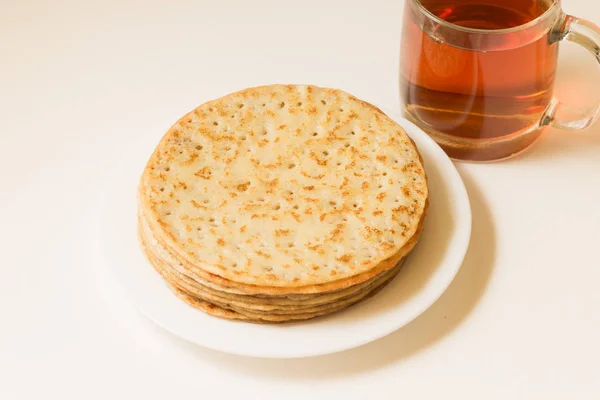 Krep yerken üzerine beyaz bir tabak ve bir fincan çay