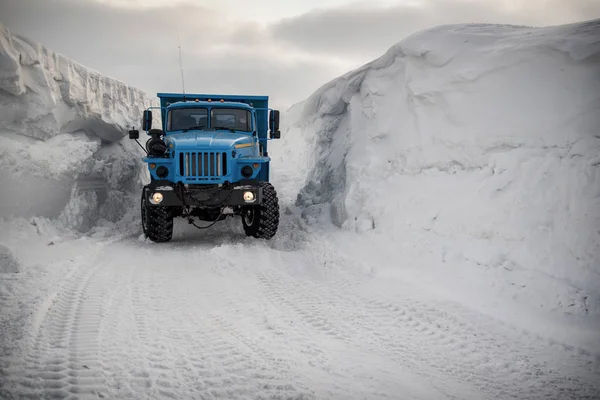 Clearing snow in the Arctic, dump trucks take it out