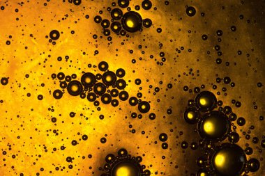 Kabarcıkları, damlaları ve renk eğimleriyle altın arkaplan. Bal deseni, parlak ışık. Bira bardağına benziyor.