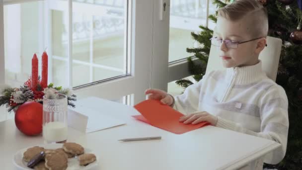 Jongetje Vouw Brief Aan Kerstman Kind Zet Zijn Geschriften Binnen — Stockvideo