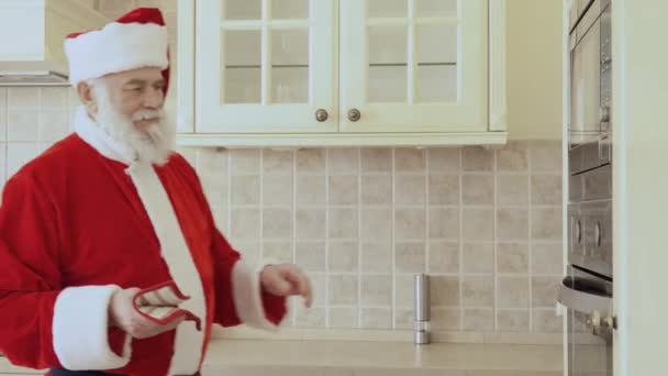 Santa Claus Zieht Die Plätzchen Aus Dem Großen Silbernen Ofen — Stockvideo