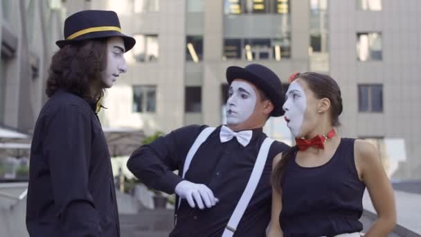 Three funny mimes have fun with each other in front of camera — Stock Video